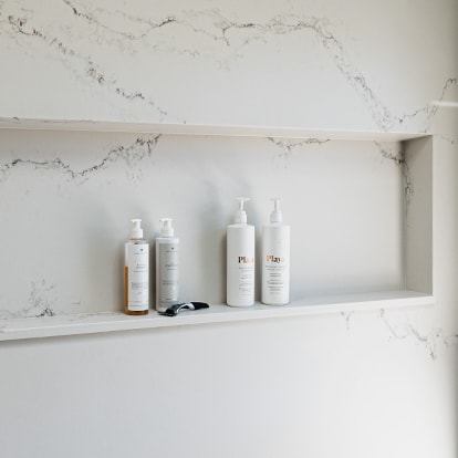 A recessed niche in a marble shower