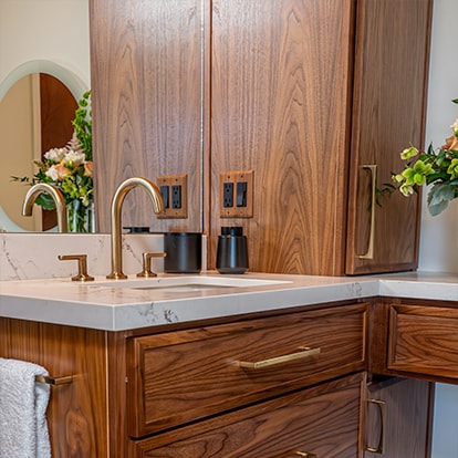 A wood vanity and vessel sink