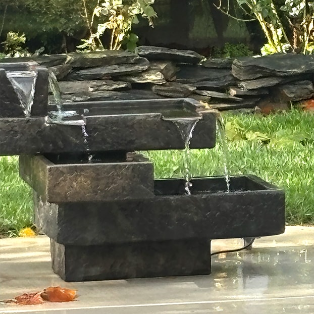 A fountain framed by garden stonework
